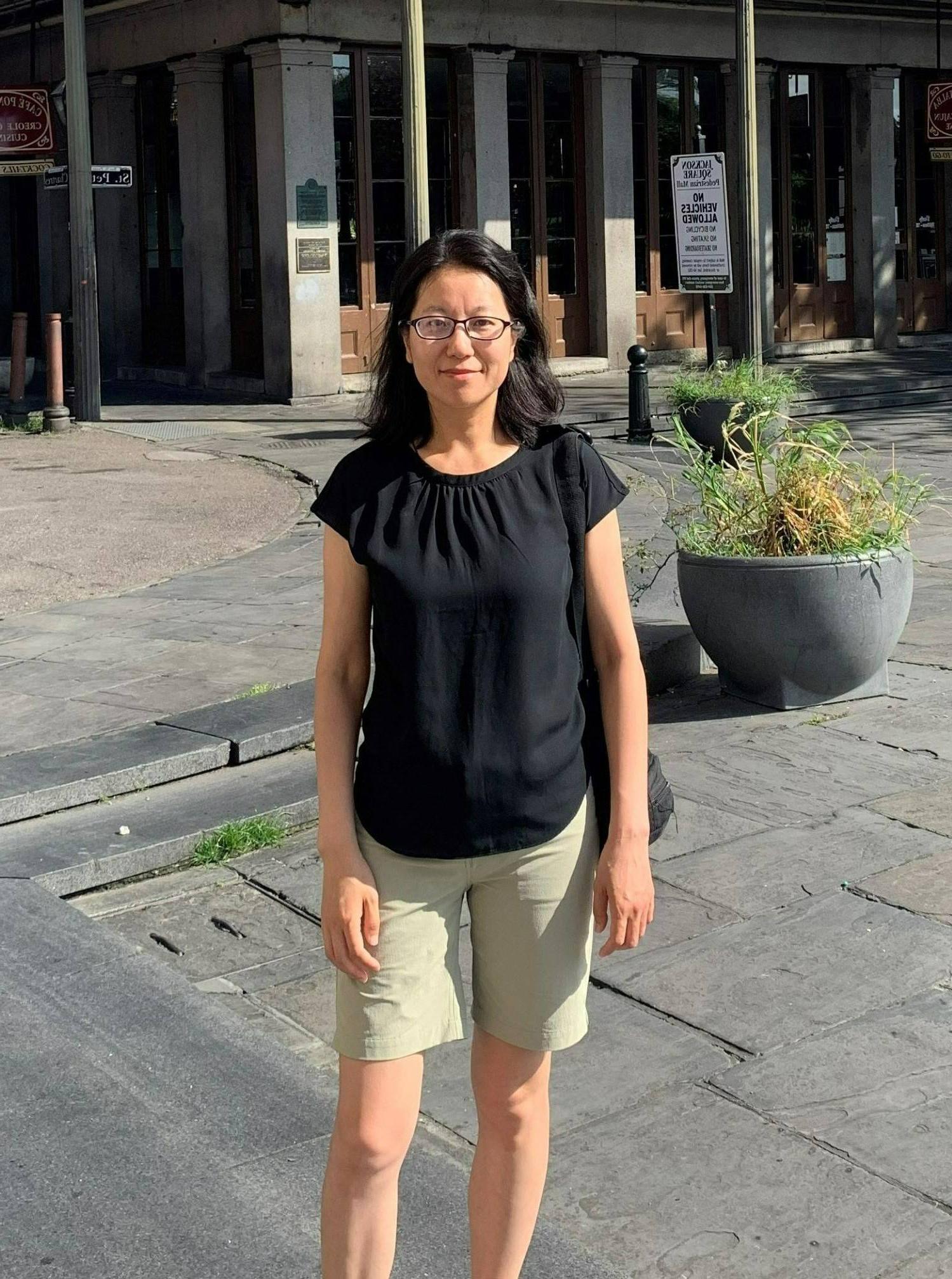 Jie Du standing in front of building